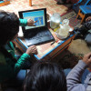 A bag leader and agronomist uses BioRegions’ diagrams to explain how grazing affects root growth to a herder family inside their ger.